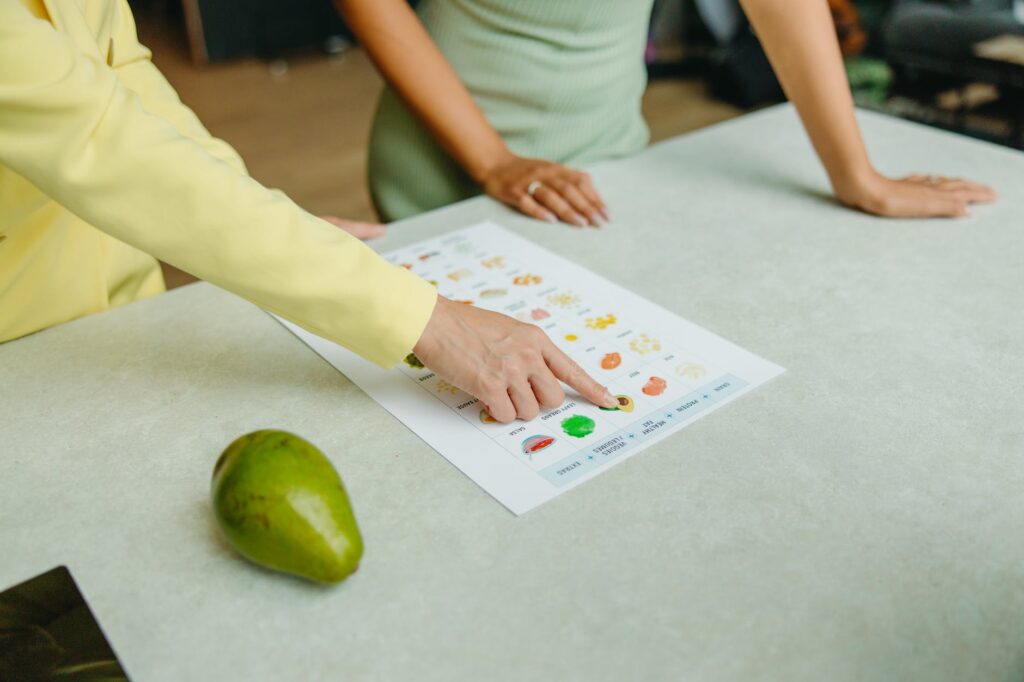 person in green shirt holding white printer paper